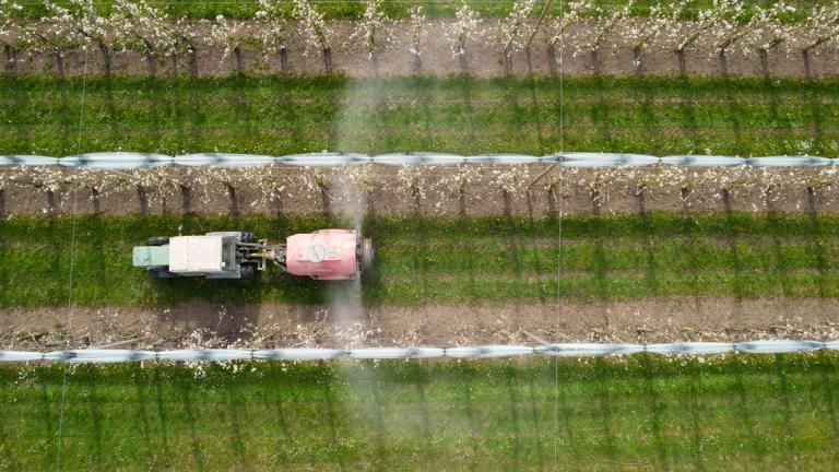 1.-print_aerial_of_tractor_spraying_chemicals_in_apple_orchard_in_germany_1.jpg